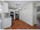 Bright kitchen featuring white cabinets, stainless steel appliances, and terracotta tile flooring at 945 Hamilton Ct, Palm Harbor, FL 34683