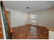 Bright living room with terracotta tile flooring and natural light from the window at 945 Hamilton Ct, Palm Harbor, FL 34683