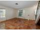 Bright living room showcasing terracotta tile floors and natural lighting from the windows at 945 Hamilton Ct, Palm Harbor, FL 34683
