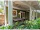 Charming patio with brick floors, an outdoor dining table, and a green exterior at 945 Hamilton Ct, Palm Harbor, FL 34683