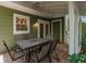 Charming patio with brick floors, an outdoor dining table, and a green exterior at 945 Hamilton Ct, Palm Harbor, FL 34683