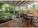 Relaxing outdoor patio with clay tiles, a dining table, and lush greenery at 945 Hamilton Ct, Palm Harbor, FL 34683