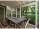 Charming outdoor patio with a dining table, clay tile flooring and lush greenery around the perimeter at 945 Hamilton Ct, Palm Harbor, FL 34683
