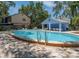 Community pool featuring a pool house, chaise lounges, tables, chairs, and a clear swimming pool at 945 Hamilton Ct, Palm Harbor, FL 34683