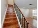 Wooden staircase with a painted white base and green metal railing at 945 Hamilton Ct, Palm Harbor, FL 34683