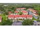 Aerial view of condo community with pool, lush trees, and ample parking space at 9481 Highland Oak Dr # 212, Tampa, FL 33647