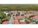 Aerial view of neighborhood, highlighting community pool and wooded backdrop at 9481 Highland Oak Dr # 212, Tampa, FL 33647