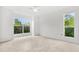 Bright bedroom features tile floors, neutral walls and two large windows at 9481 Highland Oak Dr # 212, Tampa, FL 33647