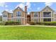 Inviting two-story condo with well-maintained landscaping and a lush green lawn at 9481 Highland Oak Dr # 212, Tampa, FL 33647