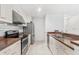 Kitchen boasts stainless appliances, tile backsplash, and white cabinetry, offering a clean aesthetic at 9481 Highland Oak Dr # 212, Tampa, FL 33647