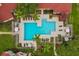 Aerial view of community pool surrounded by lush tropical landscaping at 9481 Highland Oak Dr # 212, Tampa, FL 33647