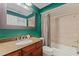 Bathroom featuring a granite vanity and a shower/tub with a curtain at 10053 W Bay St, Seminole, FL 33776