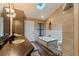 Bright bathroom featuring a double vanity, a soaking tub, and tile flooring at 10053 W Bay St, Seminole, FL 33776