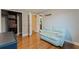 Well-lit bedroom with a light blue loveseat and a closet with built-in drawers and shelves at 10053 W Bay St, Seminole, FL 33776