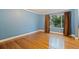 Spacious bedroom with wood floors and large window overlooking the yard at 10053 W Bay St, Seminole, FL 33776