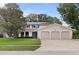 Charming two-story home with a well-manicured lawn and a three-car garage at 10053 W Bay St, Seminole, FL 33776