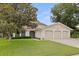 Charming two-story home with a well-manicured lawn and a three-car garage at 10053 W Bay St, Seminole, FL 33776