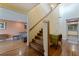 Bright foyer with hardwood floors, elegant staircase, and access to the living areas at 10053 W Bay St, Seminole, FL 33776