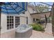 Outdoor hot tub on brick patio with a view of the home's exterior and screened-in pool at 10053 W Bay St, Seminole, FL 33776