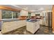 Well-lit kitchen features stainless steel appliances, custom cabinets, and an island with prep sink at 10053 W Bay St, Seminole, FL 33776