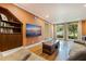 Comfortable living room featuring hardwood floors, large windows, and stylish decor at 10053 W Bay St, Seminole, FL 33776