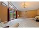 Bright living room boasts high ceilings, statement light fixture, and french doors leading to the outside at 10053 W Bay St, Seminole, FL 33776