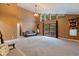 Spacious living room with high ceilings, statement light fixture, carpet, and french doors to the outside at 10053 W Bay St, Seminole, FL 33776