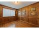 Office with hardwood paneling, hardwood floors, and a large window at 10053 W Bay St, Seminole, FL 33776