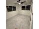Bright bedroom featuring modern ceiling fan, grey-tone tile flooring, and dual windows at 104 W Wildwood St, Tampa, FL 33613
