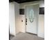 Stylish white front door with decorative glass window and painted brick surround at 104 W Wildwood St, Tampa, FL 33613