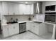 Updated kitchen with white cabinetry, stainless steel appliances, and modern backsplash at 104 W Wildwood St, Tampa, FL 33613