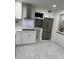 Modern kitchen featuring stainless steel appliances, white cabinets, and stylish backsplash at 104 W Wildwood St, Tampa, FL 33613