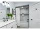 Bathroom featuring marble-look tiling, a bathtub, and a white vanity with matte black fixtures at 10520 White Lake Ct # 10520, Tampa, FL 33626