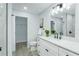Bathroom featuring a white vanity, marble countertop, matte black faucet, and an open closet at 10520 White Lake Ct # 10520, Tampa, FL 33626