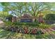Community sign for the neighborhood, surrounded by lush landscaping and colorful flowers at 10520 White Lake Ct # 10520, Tampa, FL 33626