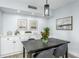 Well-lit dining area with modern decor that connects seamlessly to the contemporary, stainless steel kitchen at 10520 White Lake Ct # 10520, Tampa, FL 33626