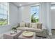 Comfortable living area features a cozy couch, stylish ottomans, and serene window view for a cozy retreat at 10520 White Lake Ct # 10520, Tampa, FL 33626