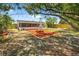 This house has a wooden fenced in yard with a picnic table and mature trees at 11520 Meadow Dr, Port Richey, FL 34668