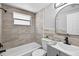 Neutral bathroom featuring decorative tile, a garden tub, and an updated vanity at 11520 Meadow Dr, Port Richey, FL 34668
