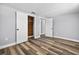 Bedroom showcasing new floors, fresh paint, and a closet with wood paneling at 11520 Meadow Dr, Port Richey, FL 34668
