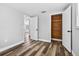 This bedroom features fresh paint, new flooring, and a unique wood paneled closet at 11520 Meadow Dr, Port Richey, FL 34668