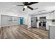 Open living space with wood-style floors, fresh paint, and an eat-in kitchen at 11520 Meadow Dr, Port Richey, FL 34668