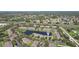 A tranquil aerial view of the condominiums, nestled around a pond with lush landscaping and ample parking at 12228 Foxmoor Peak Dr, Riverview, FL 33579