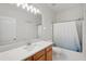 Bathroom showcasing a vanity with a sink and storage, a large mirror, and a shower with a tub at 12228 Foxmoor Peak Dr, Riverview, FL 33579