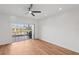 Bright bedroom featuring wood floors, a ceiling fan, and access to a private balcony at 12228 Foxmoor Peak Dr, Riverview, FL 33579