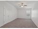 This bedroom offers cozy carpet, a ceiling fan, and a window allowing for plenty of natural light at 12228 Foxmoor Peak Dr, Riverview, FL 33579