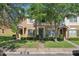 Inviting townhome with green shutters, a front lawn, and shade trees enhancing its curb appeal at 12228 Foxmoor Peak Dr, Riverview, FL 33579