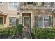 Close-up of a charming townhome entrance with lush greenery and a welcoming front door at 12228 Foxmoor Peak Dr, Riverview, FL 33579