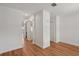 Bright hallway featuring wood floors, white trim, and an arched entryway to the kitchen at 12228 Foxmoor Peak Dr, Riverview, FL 33579