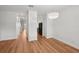 Open living space with sleek wood floors connecting to the kitchen and staircase at 12228 Foxmoor Peak Dr, Riverview, FL 33579